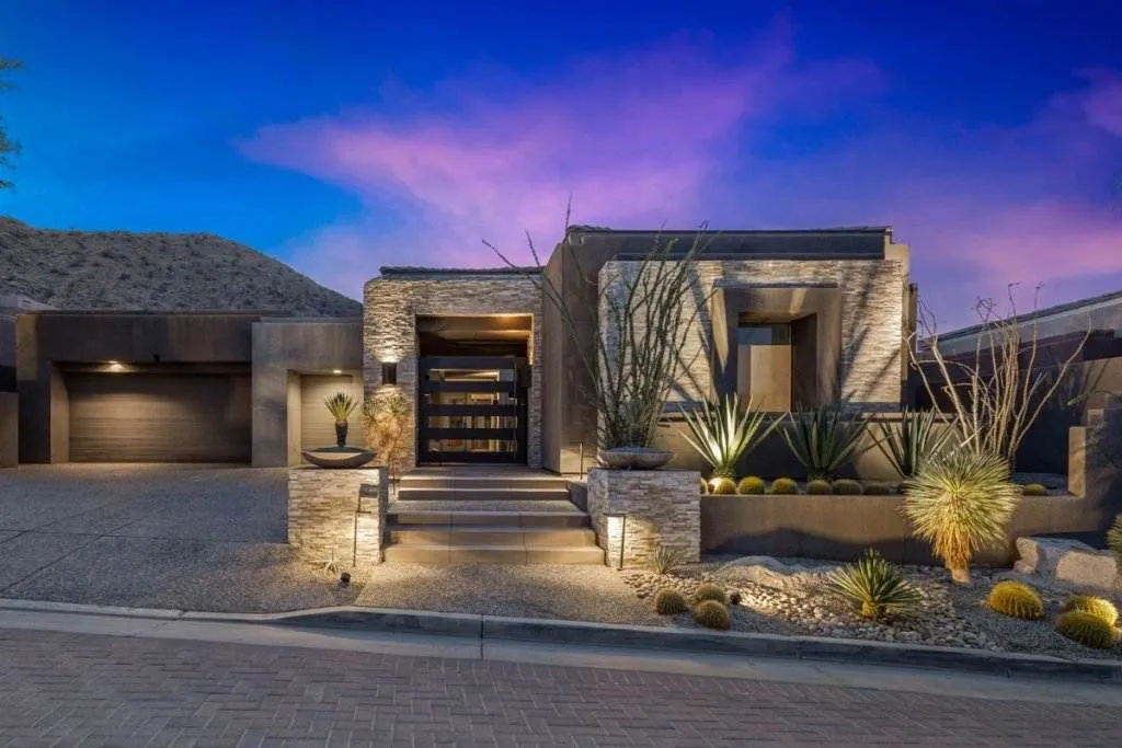 Las Vegas home value: stone and glass luxury home at dusk